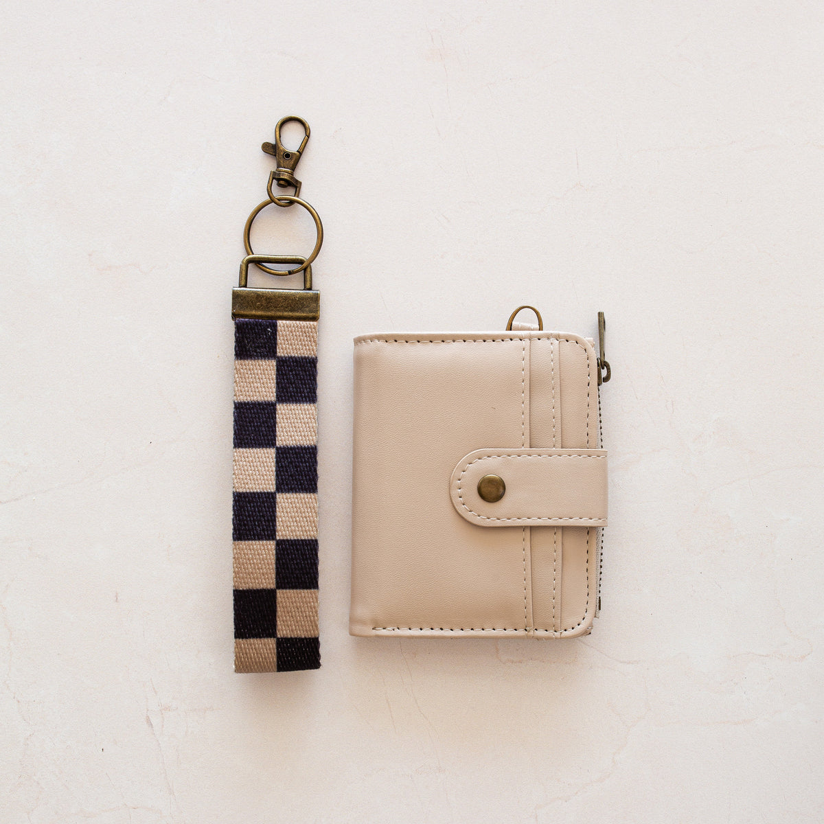 Beige bifold wallet with Black Tan Checker wrist lanyard