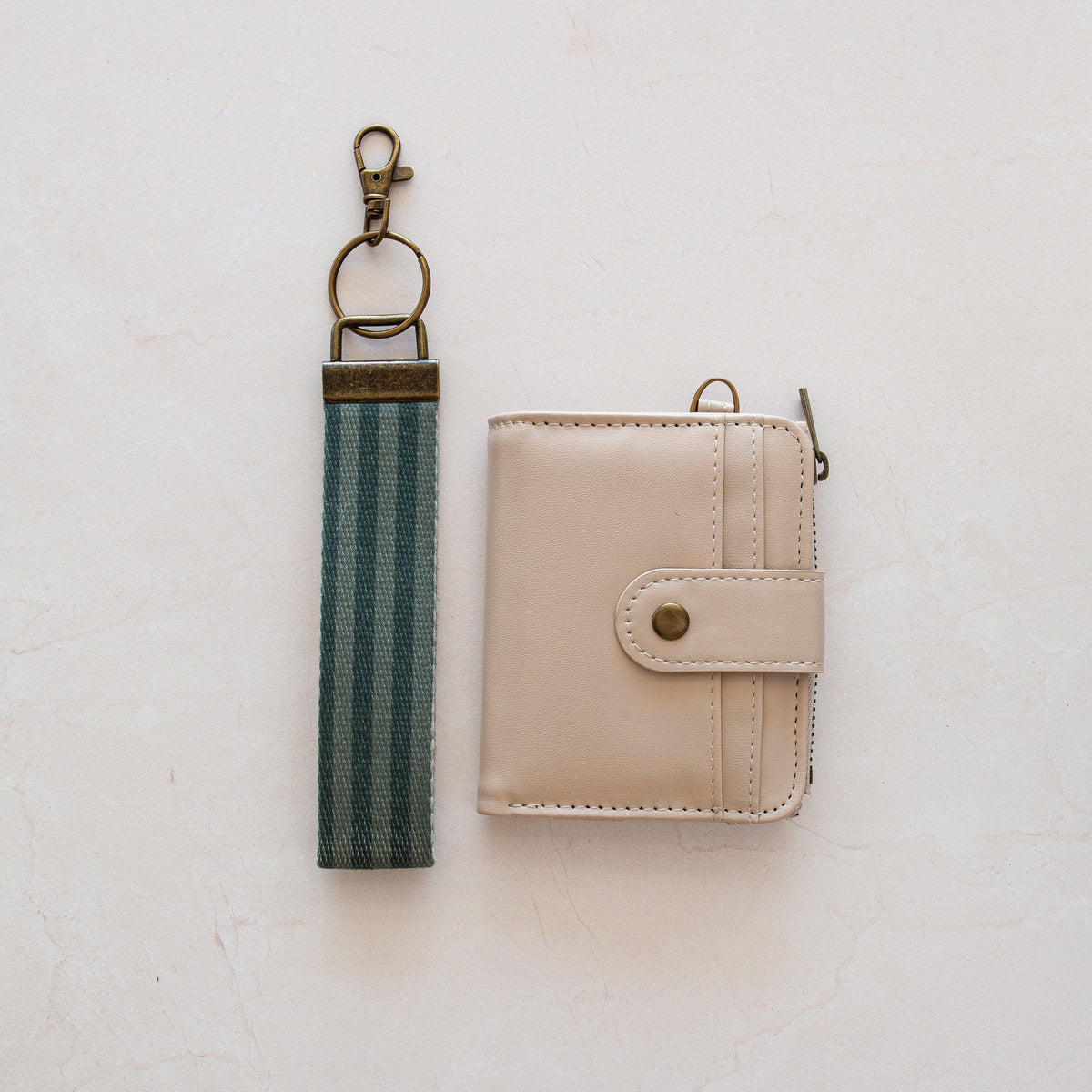 Beige bifold wallet with Greens Stripe wrist lanyard