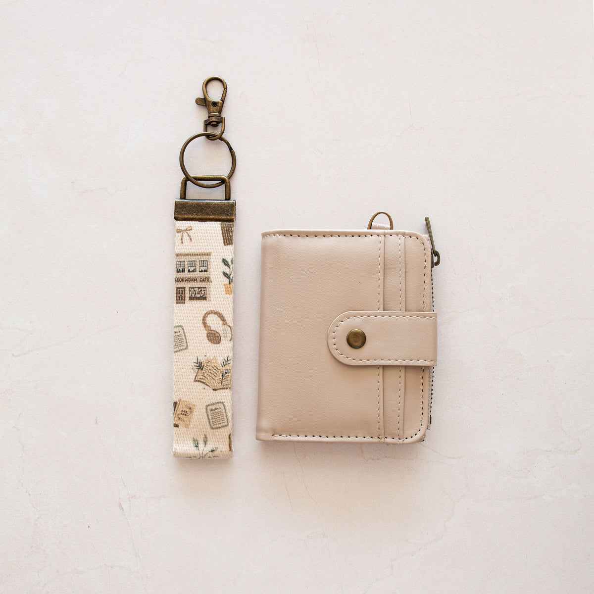 Beige bifold wallet with Bookworm Cafe wrist lanyard