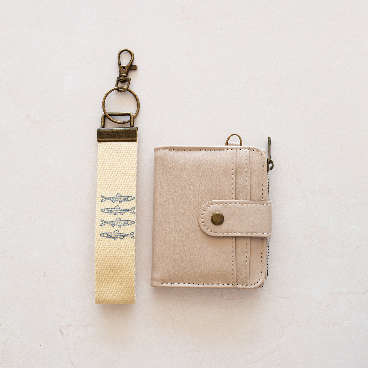 Beige bifold wallet with Sardines wrist lanyard