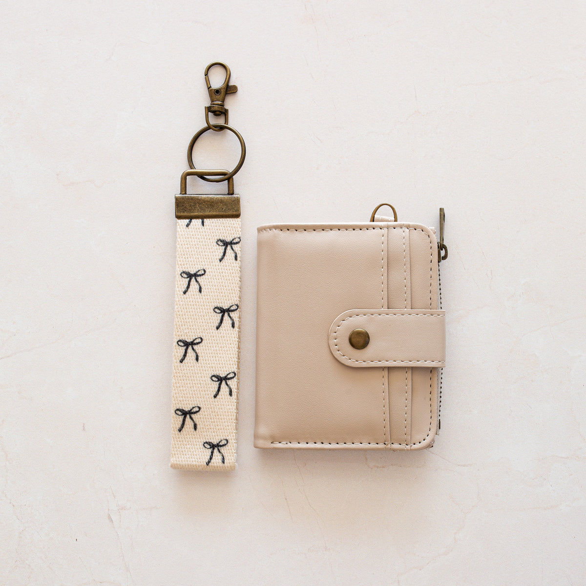 Beige bifold wallet with Black Bow wrist lanyard