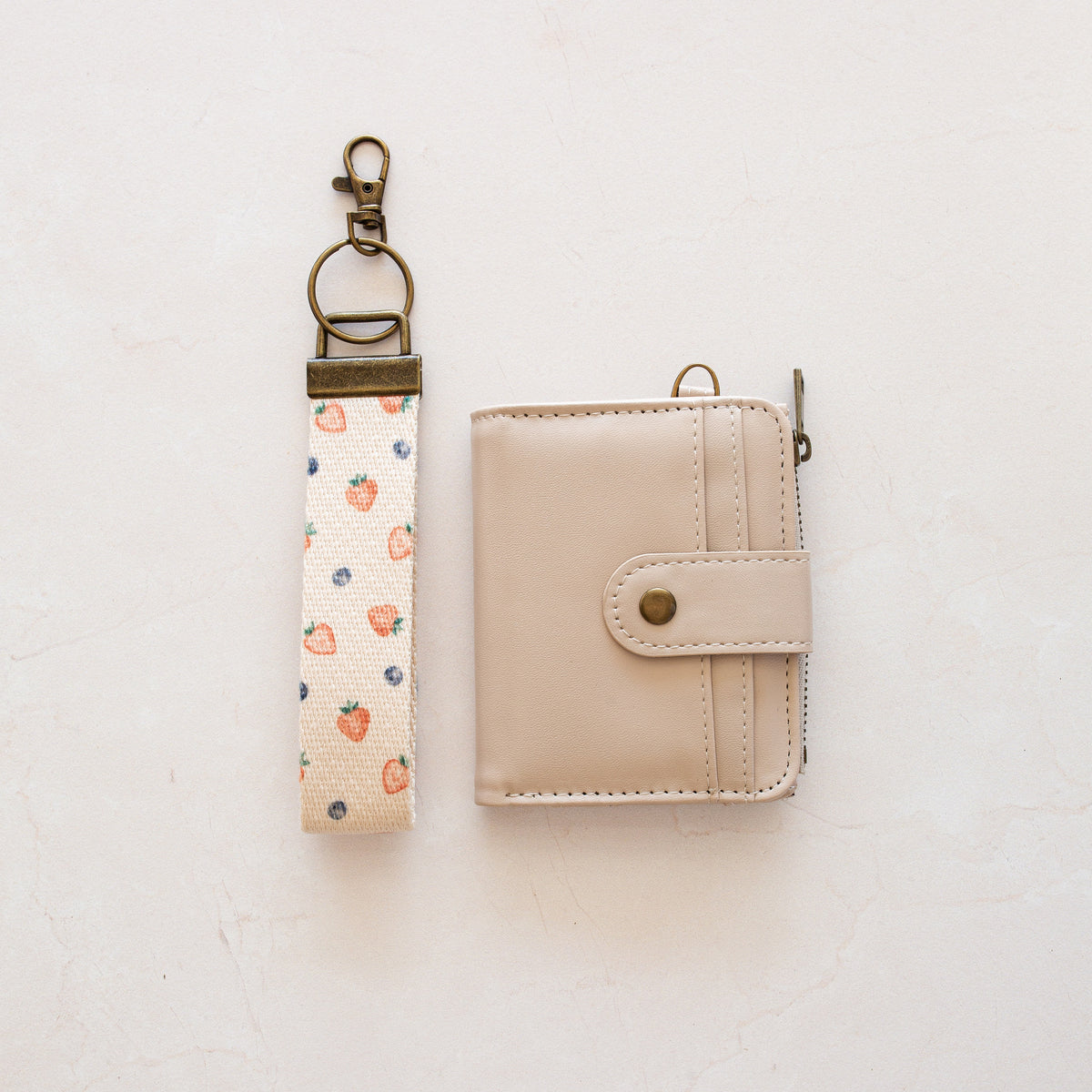 Beige bifold wallet with Berry wrist lanyard
